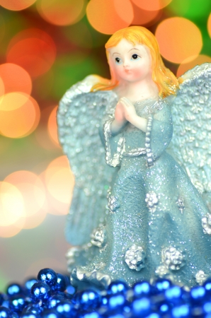 christmas decoration, figure of blue angel against bokeh backgroundの写真素材