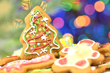 Delicious decorated Christmas cookies on bokeh backgroundの写真素材