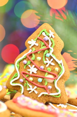 Delicious decorated Christmas cookies on bokeh backgroundの写真素材