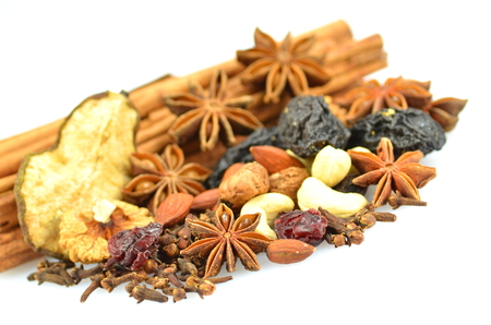 christmas spices, nuts and dried fruits isolated on white background の写真素材