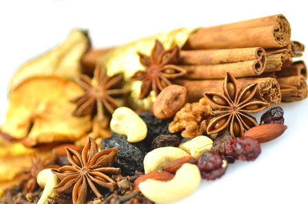 christmas spices, nuts and dried fruits isolated on white background の写真素材