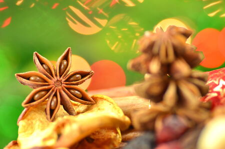 christmas spices, nuts and dried fruits on bokeh background の写真素材
