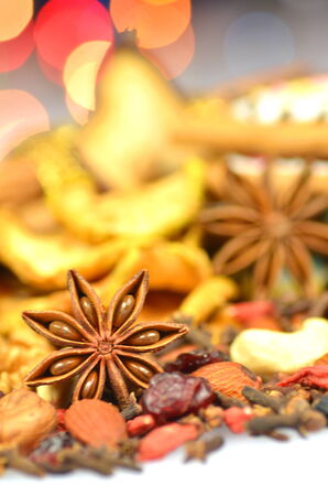christmas spices, nuts, cookies and dried fruits on bokeh background の写真素材