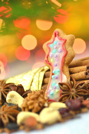 christmas spices, nuts, cookies and dried fruits on bokeh background の写真素材