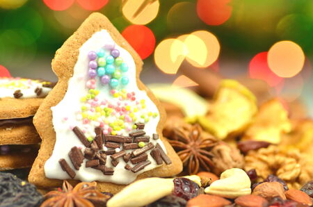 christmas spices, nuts, cookies and dried fruits on bokeh background の写真素材