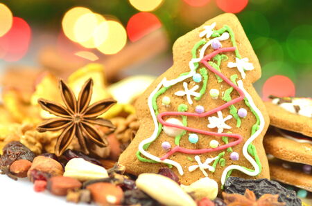 christmas spices, nuts, cookies and dried fruits on bokeh background の写真素材