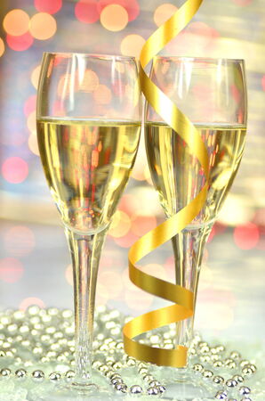 two glasses of champagne against bokeh の写真素材