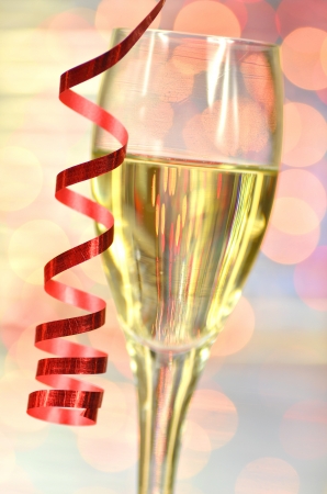 a glass of champagne against bokeh の写真素材