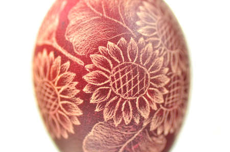 Traditional scratched handmade Easter egg on white backgroundの写真素材