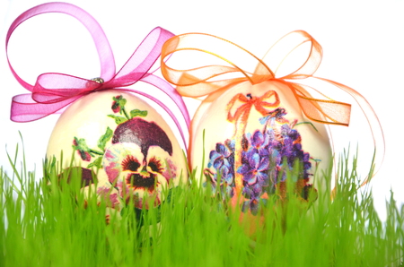 Easter eggs decorated with flowers made by decoupage technique in the grassの写真素材
