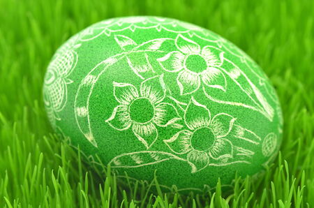 traditional scratched handmade Easter egg on the grassの写真素材
