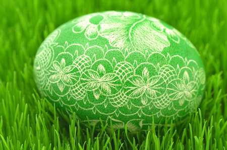traditional scratched handmade Easter egg on the grassの写真素材
