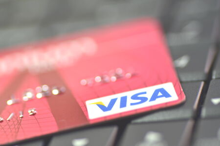 Closeup of VISA credit card on laptop keyboardのeditorial素材