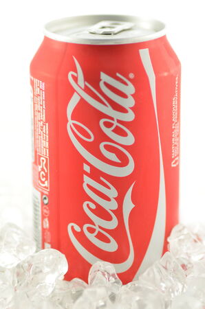 Coca-Cola drink in a can on ice isolated on white backgroundのeditorial素材