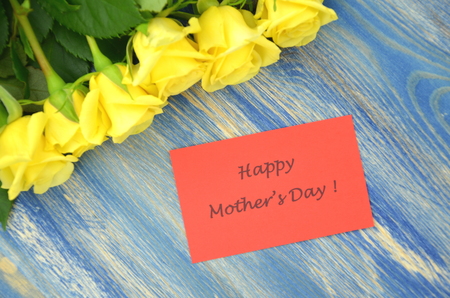 happy mothers day and bouquet of gorgeous yellow rosesの写真素材
