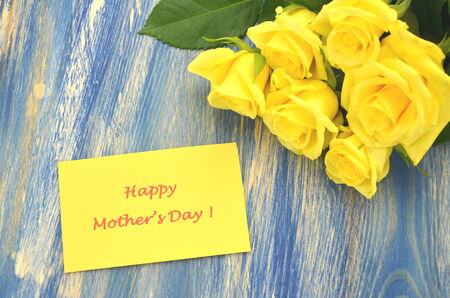 happy mothers day and bouquet of gorgeous yellow rosesの写真素材