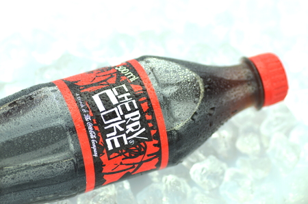 Bottle of Cherry Coke drink on ice cubesのeditorial素材