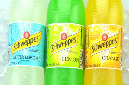 Bottles of Schweppes drink on ice cubesのeditorial素材
