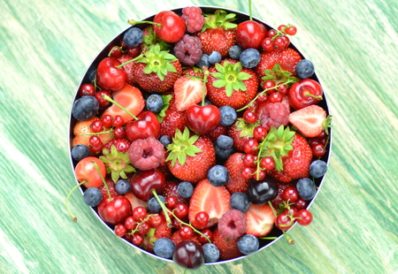variety of soft fruits, strawberries, raspberries, cherries, blueberries, currants on tableの写真素材