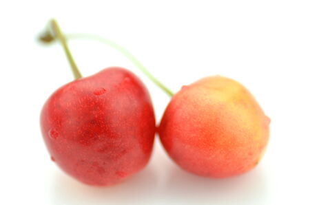 closeup of ripe, fresh and sweet cherries isolated on whiteの写真素材