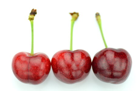 closeup of ripe, fresh and sweet cherries isolated on whiteの写真素材