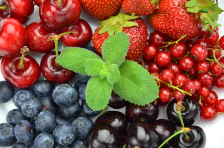 variety of soft fruits, strawberries, raspberries, cherries, blueberries, currants isolated on whiteの写真素材