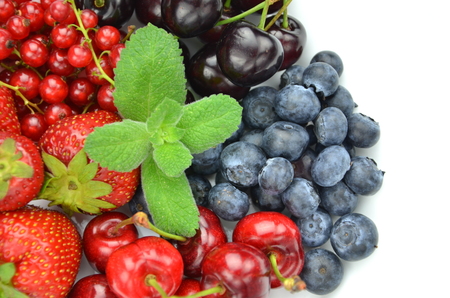 variety of soft fruits, strawberries, raspberries, cherries, blueberries, currants isolated on whiteの写真素材