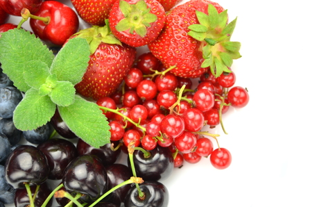 variety of soft fruits, strawberries, raspberries, cherries, blueberries, currants isolated on whiteの写真素材