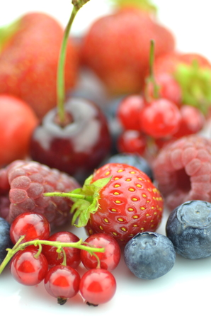 variety of soft fruits, strawberries, raspberries, cherries, blueberries, currants isolated on whiteの写真素材
