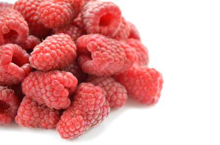 closeup of ripe, fresh and sweet raspberries isolated on whiteの写真素材