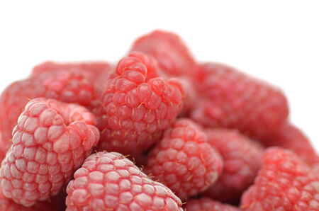 closeup of ripe, fresh and sweet raspberries isolated on whiteの写真素材
