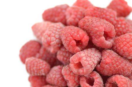 closeup of ripe, fresh and sweet raspberries isolated on whiteの写真素材