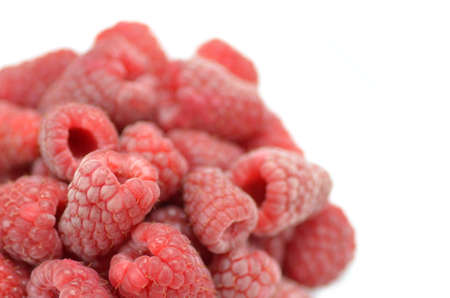 closeup of ripe, fresh and sweet raspberries isolated on whiteの写真素材