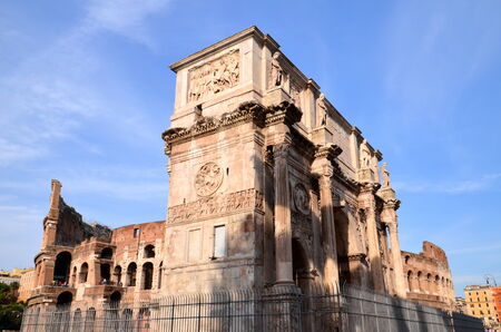 Triumphal Arch of Constantine and Colosseum in Rome against blue sky, Italyのeditorial素材