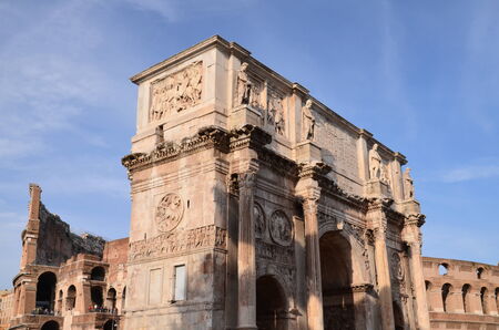 Triumphal Arch of Constantine and Colosseum in Rome against blue sky, Italyのeditorial素材