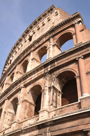 Monumental ancient Colosseum in Rome against blue sky, Italyのeditorial素材