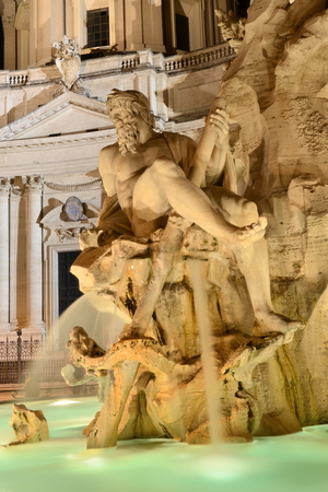 Beautiful Fountain of the Four Rivers by night on Piazza Navona in Rome, Italyの写真素材