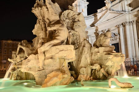 Beautiful Fountain of the Four Rivers by night on Piazza Navona in Rome, Italyの写真素材