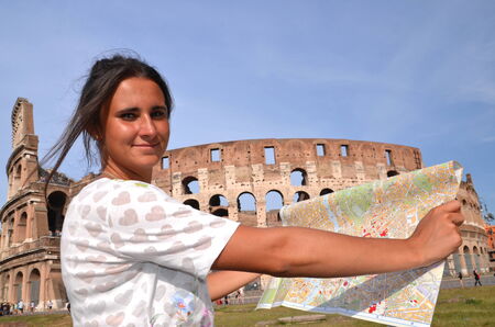 beautiful attractive brunette tourist girl close to majestic Colosseum in Rome, Italyの写真素材