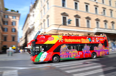 Dashing city sightseeing open top bus in Rome, Italyのeditorial素材