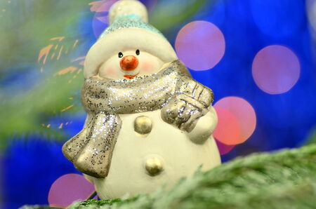 christmas decoration, figure of snowman against bokeh backgroundの写真素材