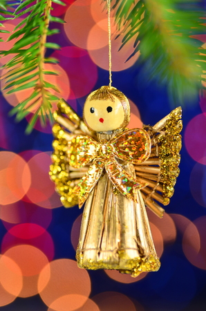 christmas decoration, golden angel made of straw against bokeh backgroundの写真素材