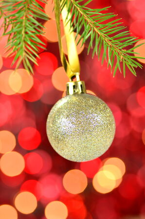 christmas decoration, Christmas ball hanging on spruce twig against bokeh backgroundの写真素材