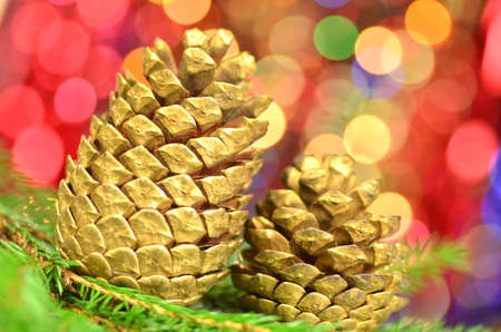 christmas decoration, golden cones against bokeh background