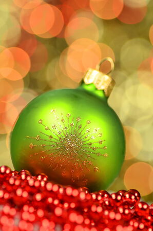 christmas decoration, green Christmas ball in bokeh backgroundの写真素材