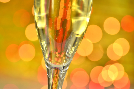 a glass of champagne on bokeh backgroundの写真素材