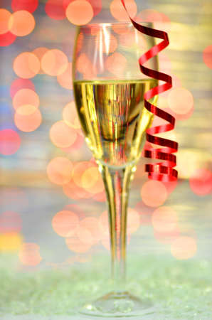 a glass of champagne on bokeh backgroundの写真素材