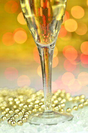 a glass of champagne on bokeh backgroundの写真素材