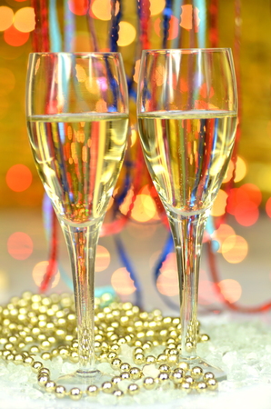 two glasses of champagne on bokeh backgroundの写真素材