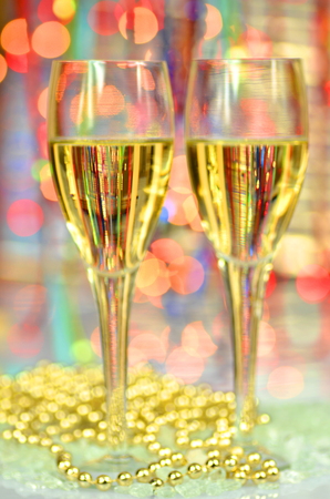 two glasses of champagne on bokeh backgroundの写真素材